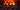 A close-up view of orange and yellow electric fireplace flames glowing behind dark logs in a brick chimney.
