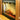 An electric fireplace features glowing artificial logs. It sits beside a metal basket in a warmly lit room.